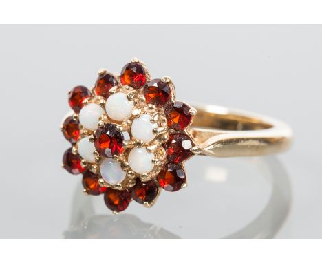 OPAL AND GARNET CLUSTER RING
the stones in a floral motif, hallmarked nine carat yellow gold, size P