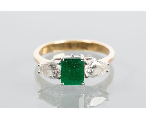 EMERALD AND DIAMOND THREE STONE RING
the central step cut emerald approximately 0.80 carats, flanked by two pear cut diamonds