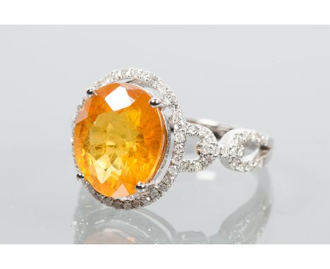 ORANGE SAPPHIRE AND DIAMOND CLUSTER RING
the central oval cut orange sapphire approximately 5.75 carats, surrounded by diamon