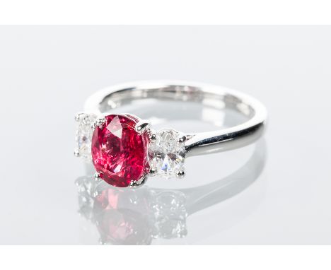 RUBY AND DIAMOND THREE STONE RING
the central oval ruby approximately 3.18 carats, flanked by two oval cut diamonds totalling