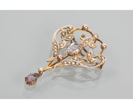 EDWARDIAN AMETHYST AND SEED PEARL HOLBEIN
of scrolling openwork form, with a central oval amethyst surrounded by seed pearls,