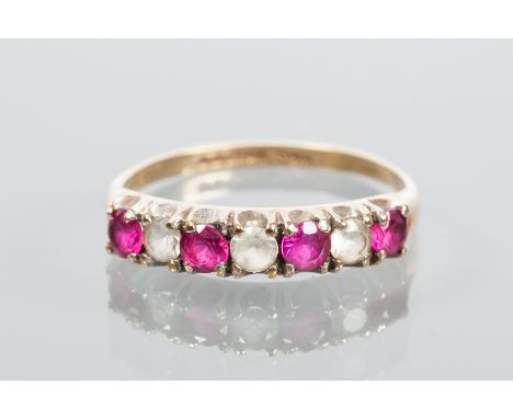 NINE CARAT GOLD RUBY RING
set with alternating rubies and white stones, hallmarked nine carat gold, size R