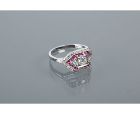 ART DECO STYLE RUBY AND DIAMOND RING
the central brilliant cut diamond approximately 0.3 carats, flanked by two smaller diamo