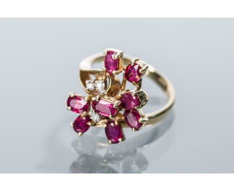 UNUSUAL RUBY AND DIAMOND CLUSTER RING
set with eight oval rubies and three brilliant cut diamonds, in fourteen carat yellow g