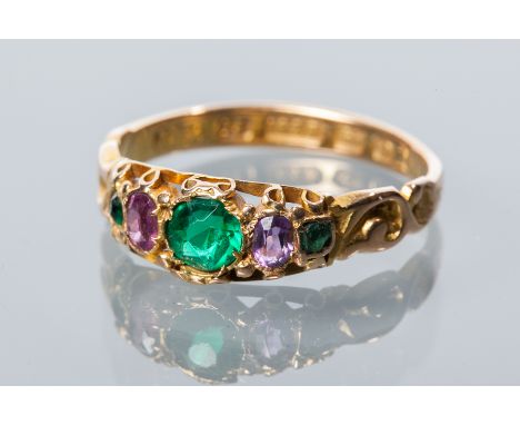 VICTORIAN FIFTEEN CARAT GOLD RING
set with green and purple stones, in scrolling setting, hallmarked fifteen carat gold, size