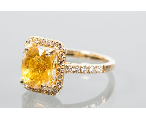 YELLOW SAPPHIRE AND DIAMOND CLUSTER RING
the central oval cut yellow sapphire approximately 3.58 carats, surrounded by diamon