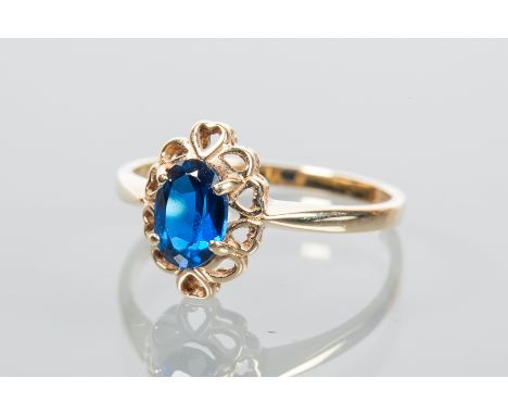 BLUE GEM SET RING
with a central oval cut blue gem in a pierced setting, hallmarked for nine carat gold, size L-M