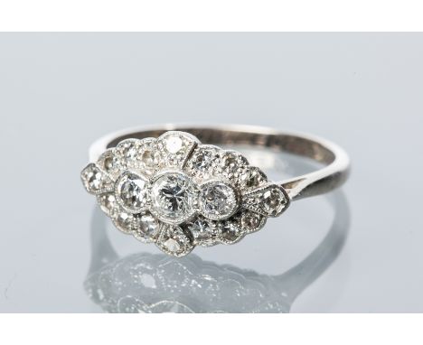 1940s DIAMOND CLUSTER RING
set with a row of three central brilliant cut diamonds, surrounded by diamonds, marked 18ct and PT
