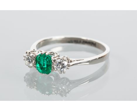 EMERALD AND DIAMOND THREE STONE RING
the central step cut emerald approximately 0.53 carats, flanked by two brilliant cut dia