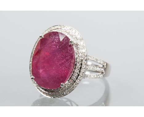 RUBY AND DIAMOND CLUSTER RING
the central oval cut ruby approximately 13.50 carats, surrounded by diamonds totalling approxim