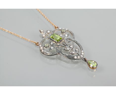 PERIDOT, DIAMOND AND SEED PEARL PENDANT
of floral design, set with a central emerald cut peridot, surrounded by diamonds and 