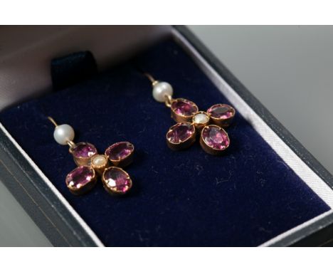 PAIR OF ALMANDINE GARNET AND SEED PEARL DROP EARRINGS
of floral form, each set with four oval cut garnets with a central seed