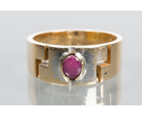 GENTLEMAN'S STAR RUBY RING
the oval cabochon ruby displaying asterism, with pierced zig zag decoration, marked 585 for fourte