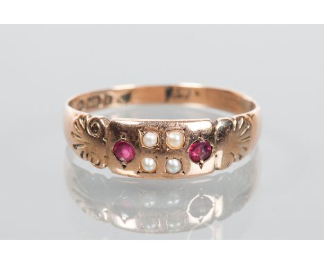 VICTORIAN RUBY AND PEARL RING
the rectangular bezel set with seed pearls and rubies, on ornate scroll motif shoulders, in nin