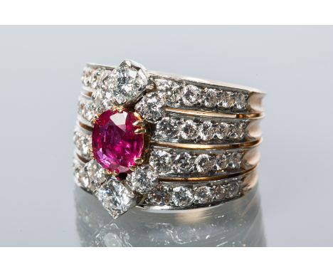 IMPRESSIVE RUBY AND DIAMOND DRESS RING
the central oval cut ruby approximately 1.68 carats, set between two clusters of three