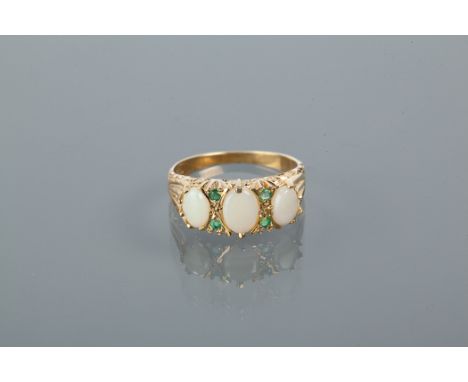 SYNTHETIC OPAL AND EMERALD RING
set with three oval cabochon synthetic opals, separated by emeralds, in silver gilt, size N-O