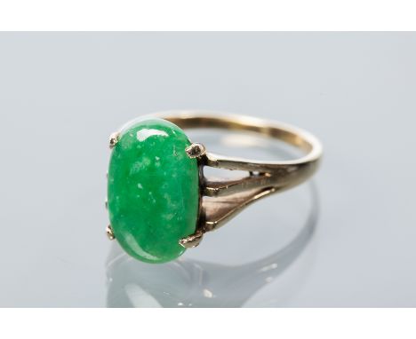 JADE RING
set with an oval cabochon section of jade measuring 14.4 x 9.3mm, marked 18k, size R