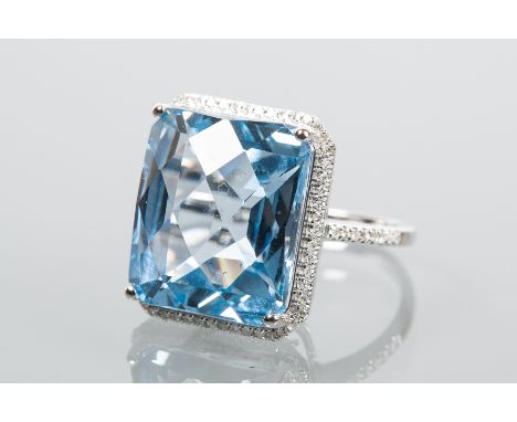 TOPAZ AND DIAMOND CLUSTER RING
the large rectangular topaz approximately 24 carats, surrounded by diamonds totalling approxim