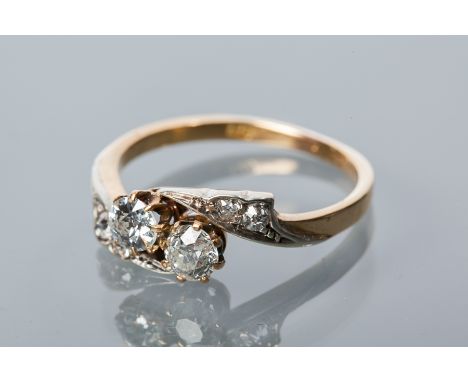 DIAMOND TWO STONE RING
set with two old cut diamonds, in a twist setting, on diamond set shoulders, the diamonds totalling ap