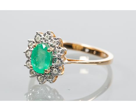 EMERALD AND DIAMOND CLUSTER RING
set with an oval cut emerald of approximately 0.60 carats, surrounded by illusion set diamon