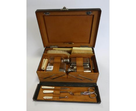 A gent's vintage leather travelling case with brushes etc 