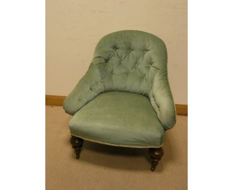 A late Victorian green buttoned upholstered elbow chair 