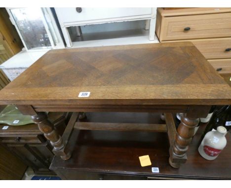 An oak coffee table with parquetry style top on bobbin turned legs 