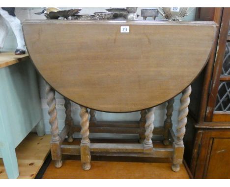 A light oak oval gate leg dining table on barley twist legs 2'6 wide 