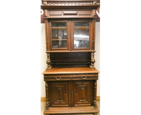 A French oak glazed buffet cabinet standing on a draw and cupboard base 45" wide 