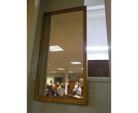 A long gilt framed mirror