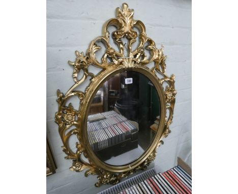 A Victorian style oval mirror in gilt frame 