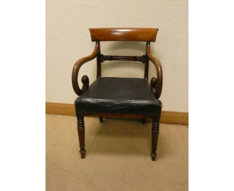 A William IV mahogany elbow chair with hooped arms standing on turned legs with black upholstered seat 