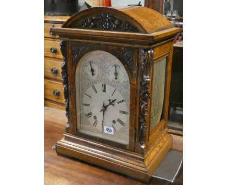 A late Victorian chiming bracket clock by Winter Halder &amp; Hoffmieir in light oak carved case with arched silver dial, 19"