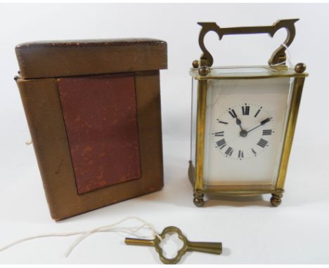A French brass carriage clock in leather travelling case, 15cms tall 
