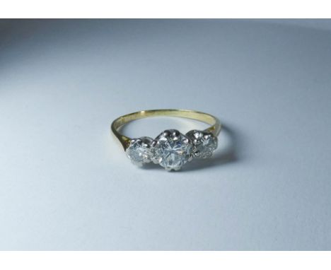 Vintage three stone diamond ring on an 18ct gold shank, ring size 'N'  The diamond measures approximately 5mm across There is