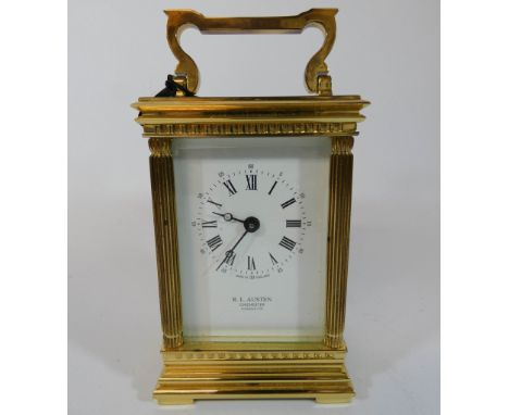 A good quality modern brass carriage clock by R L Austen, Chichester, complete with key, height with handle up 16cms 