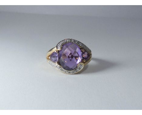 large oval 9ct gold amethyst three stone and diamond cluster ring, ring size R