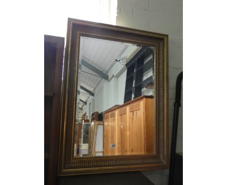 A bevelled wall mirror in gilt frame 