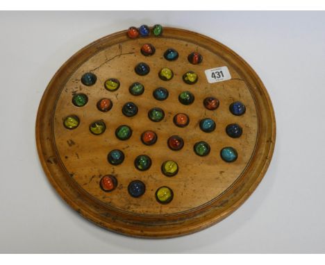 A vintage Solitaire board and marbles 