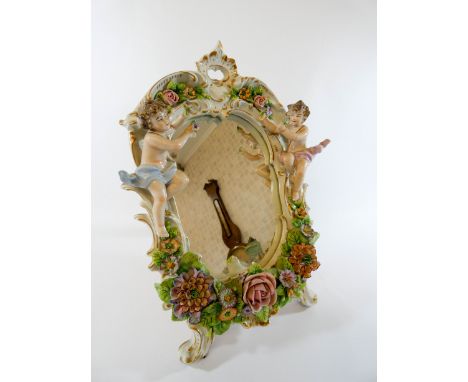 Continental porcelain cherub and floral encrusted dressing table mirror with easel fitting, blue crowned 'S' mark to the top,