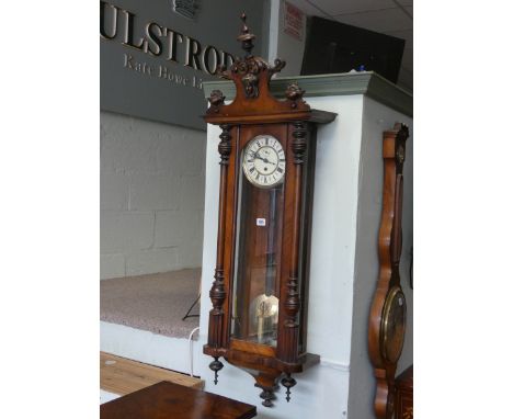 An Edwardian Vienna style wall clock in walnut glazed case
