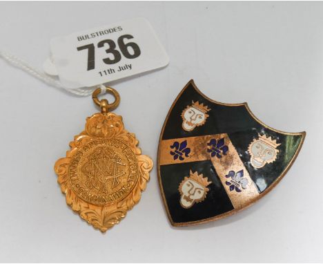 Vintage 9ct gold sporting medallion weighing 6.1 grams and an enamelled heraldic badge.
