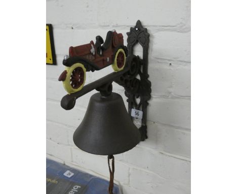 A vintage car shaped cast iron wall hanging bell 