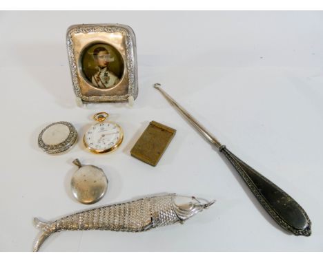 A portrait miniature of a Continental Count in a rectangle silver frame, articulated fish, silver handled button hook and oth