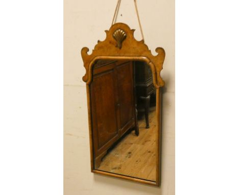 A Georgian walnut framed wall mirror and a pair of bevelled mirrors in carved decorated frames 