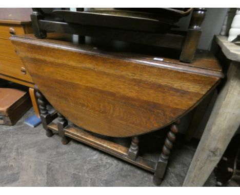 An oval oak gate leg table on barley twist legs 3'6 wide 