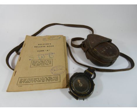 World War II issue military compass, leather carry case and a soldiers release book