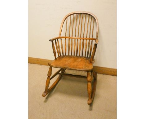 A 19th century elm hoop and stick back Windsor rocking elbow chair 