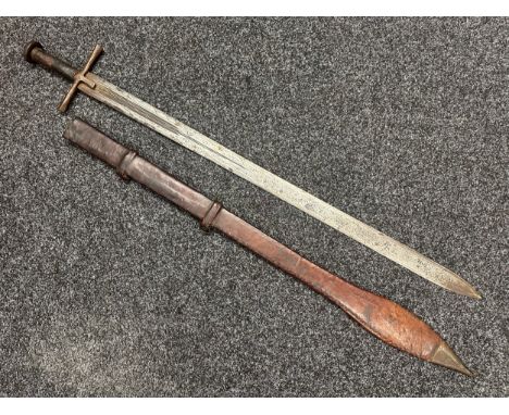 Sudanese Kaskara Sword with double edged fullered blade 935mm in length. Steel crossguard and leather bound grip. Circular st