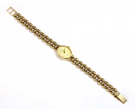 A ladies' 9ct gold Accurist quartz bracelet watch, oval dial 19 x 16mm, cream dial with baton hour markers and diamond dot at